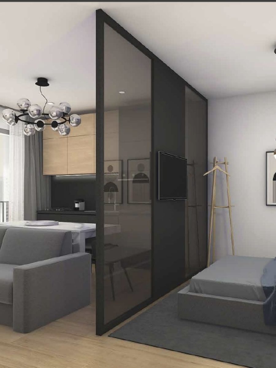 Monolocale elegante con divisione tra zona notte e giorno, arredato in stile contemporaneo.